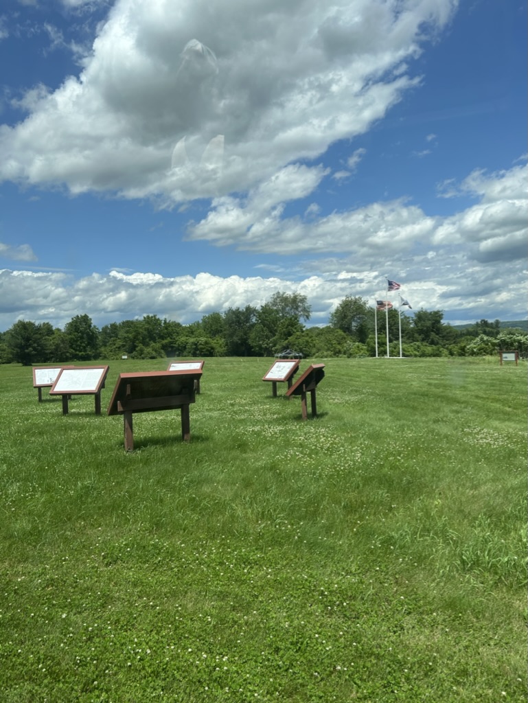 A grassy field where Fort Plain once stood, with markers describing what was there