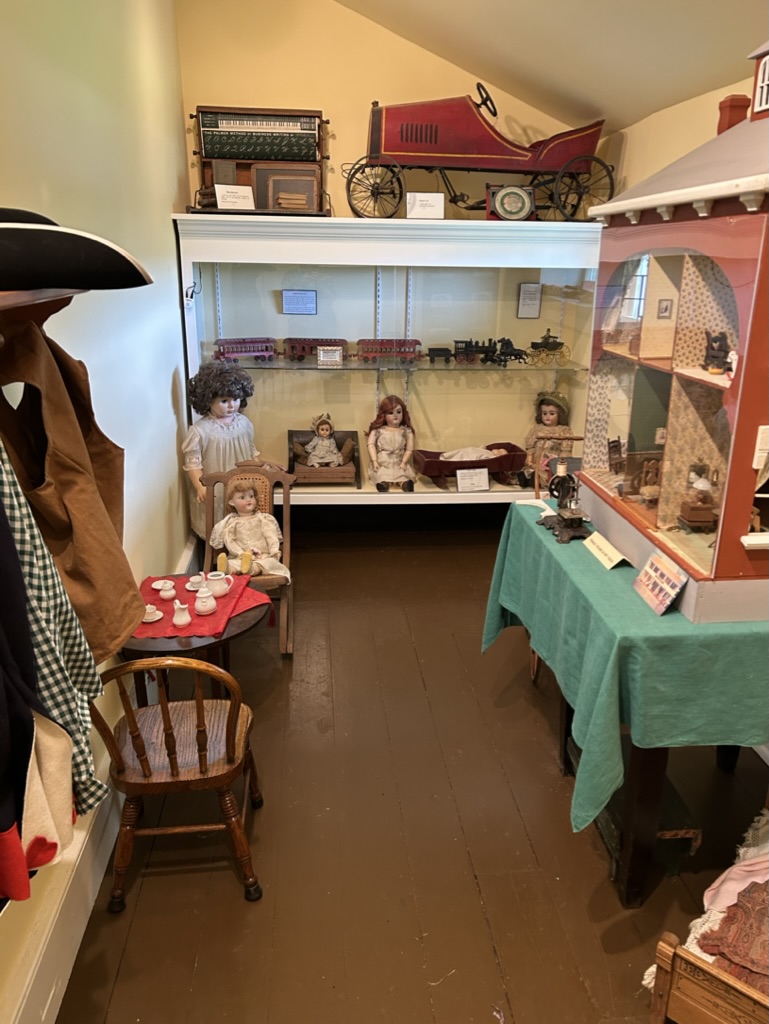 A narrow room with Revolutionary War era toys, including some no doubt haunted dolls