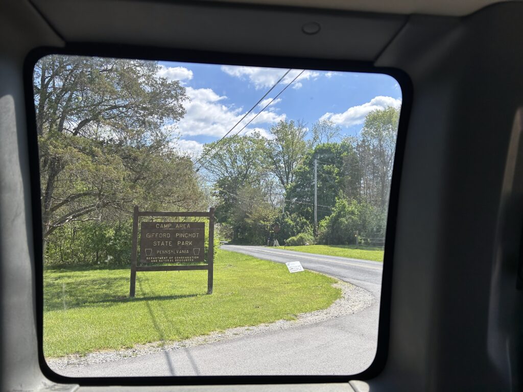 The sign at the entrance of the Camp Area of Gifford Pinchot State Park, seen through the window of a van